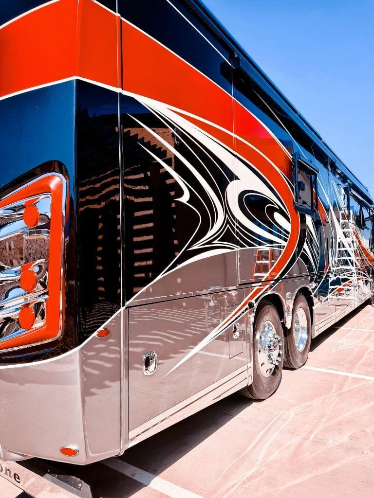 Close-up of the Entegra Cornerstone motorcoach showing mirror-like paint correction and graphic detail work at Brightworks Fort Worth