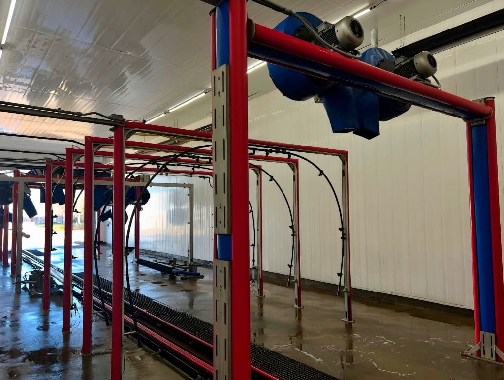 Brightworks Fort Worth exterior wash — wide view of the empty wash bay showing dryer blowers and red track system