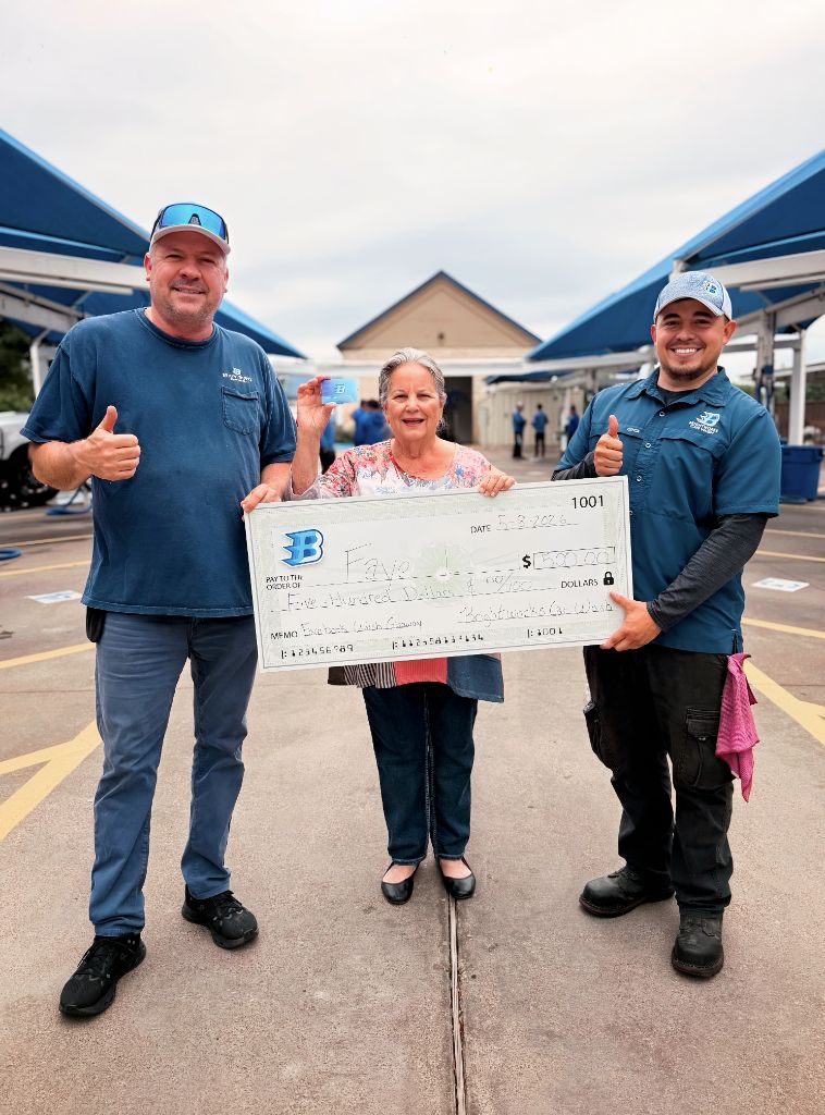 Brightworks Granbury Facebook giveaway winner Faye receiving a $500 check from the Brightworks team