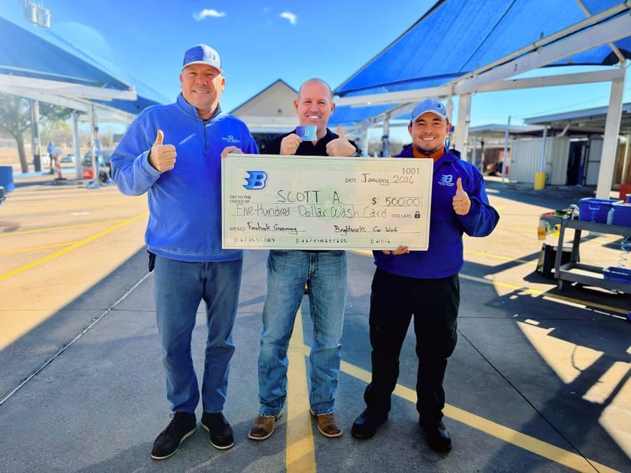 Brightworks Fort Worth Facebook giveaway winner Scott A. receiving a $500 wash card check