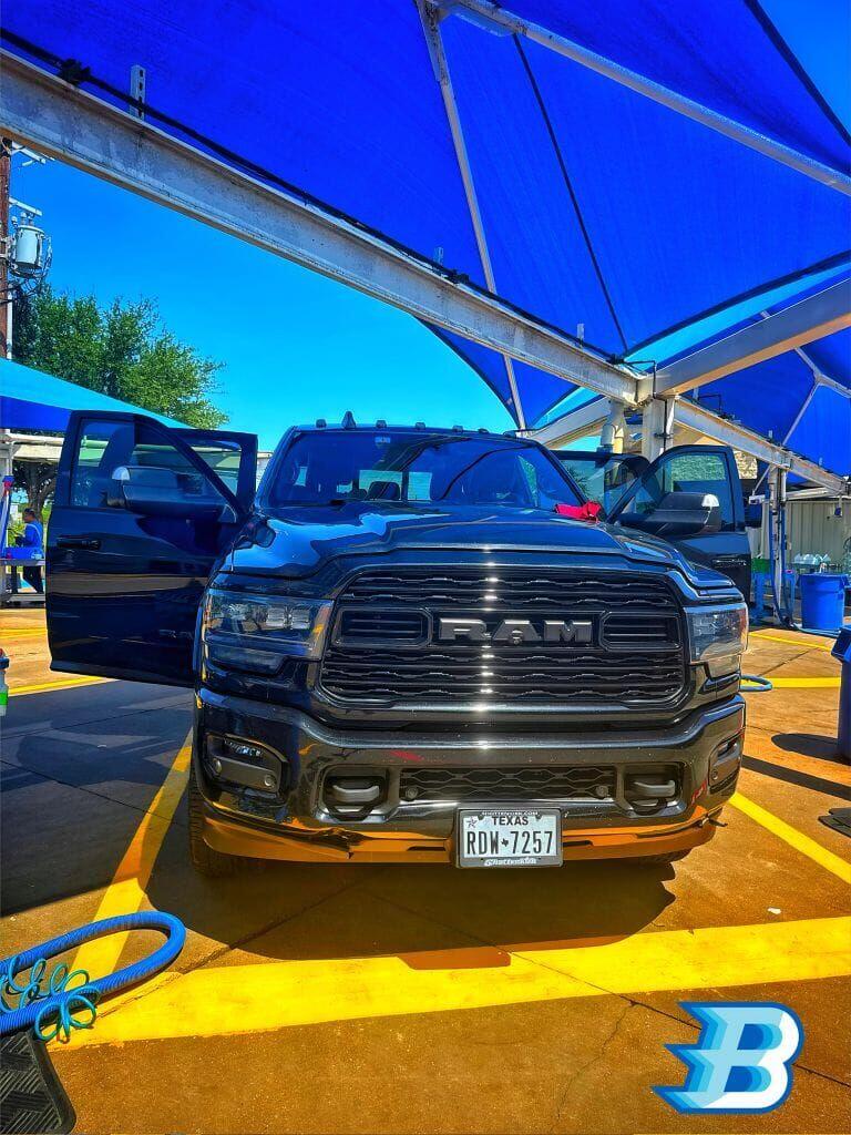 RAM 2500 truck being detailed at Brightworks Granbury under the blue shade canopy